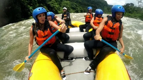 Experience the thrill of river rafting with a team of seven adventurous girls Stock Footage 128446063