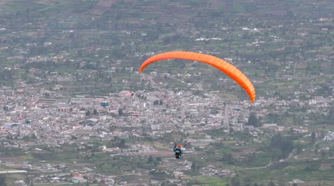 Experience the thrill of a solo paraglide flight over Patate City in Central 動画素材 58604367