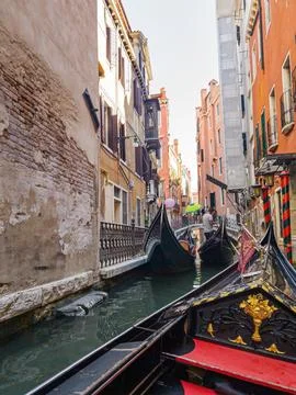 Experience Venice while gliding along its enchanting canals in a gondola Stock Photos
