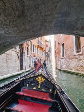 Experience Venice while gliding along its enchanting canals in a gondola Stock Photos
