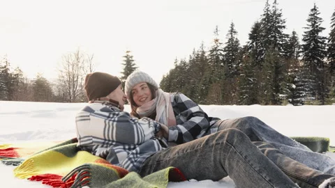 Experience the warmth of a cozy winter romance set against a breathtaking snowy Stock Footage 317027216
