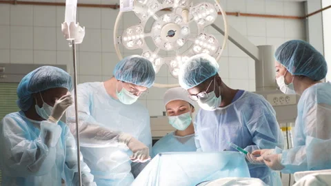 Experienced African doctor and his team perform the surgery Stock Footage