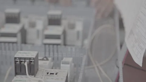 Experienced and qualified electrician engineer works in electrical cabinet Stock Footage 105214874