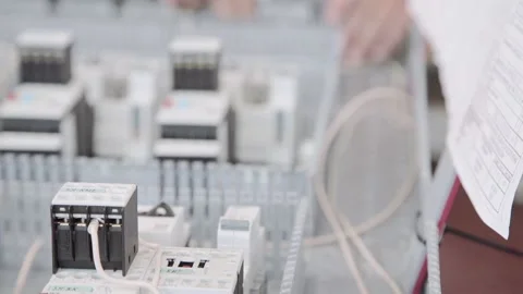 Experienced and qualified electrician engineer works in electrical cabinet Stock Footage 105216192