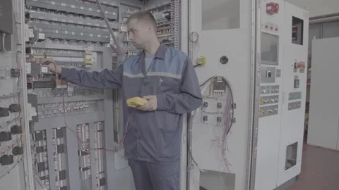 Experienced and qualified electrician engineer works in electrical cabinet Stock Footage 105218882