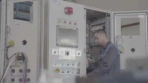 Experienced and qualified electrician engineer works in electrical cabinet Stock Footage 105221872