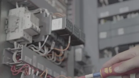 Experienced and qualified electrician engineer works in electrical cabinet Stock Footage 105286022
