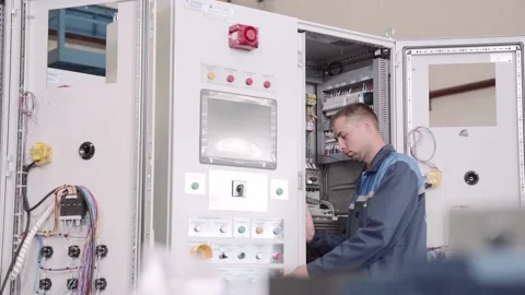 Experienced and qualified electrician engineer works in electrical cabinet Stock Footage 105286532