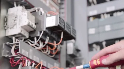 Experienced and qualified electrician engineer works in electrical cabinet Stock Footage 105287055