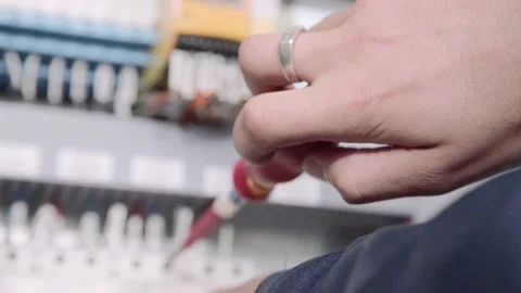 Experienced and qualified electrician engineer works in electrical cabinet Stock Footage 105288054