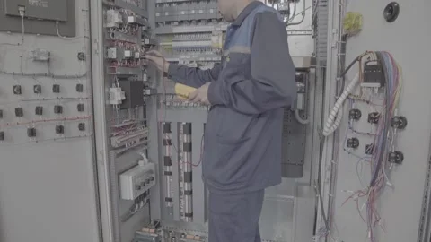Experienced and qualified electrician engineer works in electrical cabinet Video stock 105290650