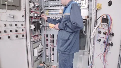 Experienced and qualified electrician engineer works in electrical cabinet Stock Footage 105290659