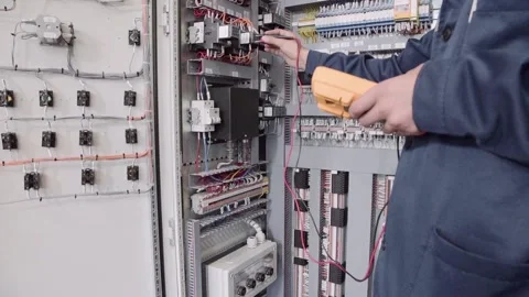 Experienced and qualified electrician engineer works in electrical cabinet Stock Footage 105292014