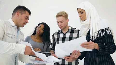 Experienced attantive 30s office workers discussing the datas from reports Stock Footage 121841724