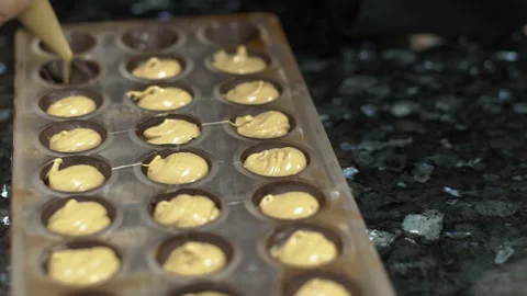 Experienced baker pours dough into forms in kitchen in pastry shop. Stock Footage 85622064