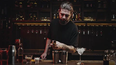 Bartender Pours Red Liquid From Jigger Into Mixing Cup Stock Photo