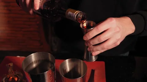 Experienced bartender preparing cocktail at bar Pouring vodka into silver shaker Stock Footage 269571451