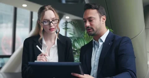Experienced businessman giving constructive feedback to female employee on Stock Footage 322106904