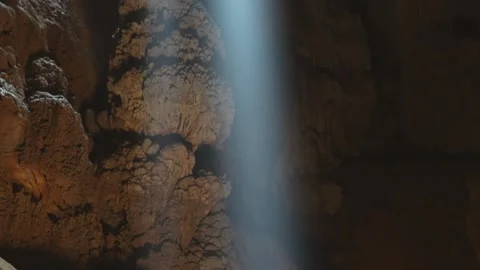 Experienced cavers explore a cave Stock Footage 245942317