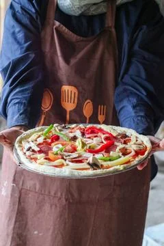 Experienced chef - process of making pizza. Professional chef prepares the .. Stock Photos