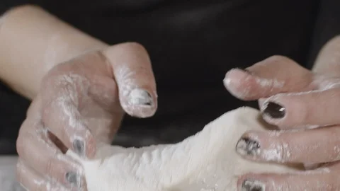 An experienced chef in a professional kitchen prepares the dough with flour Stock Footage 124877889