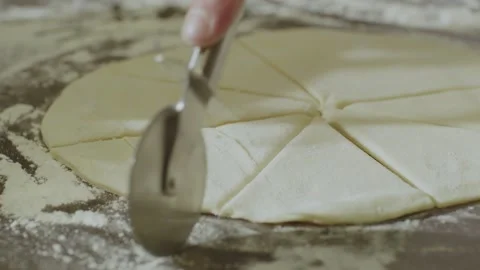 An experienced chef in a professional kitchen prepares the dough with flour. Stock Footage 153165339
