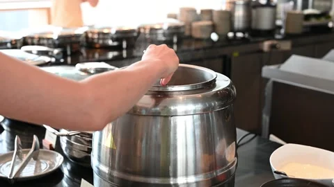 Experienced chef serving hot soup from stainless steel pot in kitchen Vídeo Stock 280937889