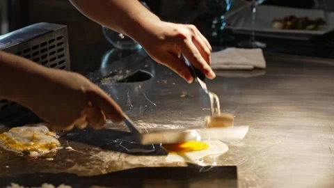 An experienced chef skillfully prepares fresh eggs in the kitchen Video stock 304955044