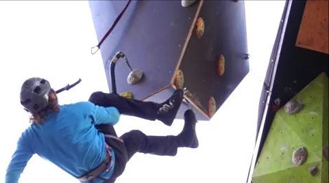 An experienced climber performs a complicated maneuver. Mountain Stock Footage 69029954