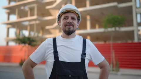 Experienced construction professional smiling confidently at a residential .. Stock Footage 341332954