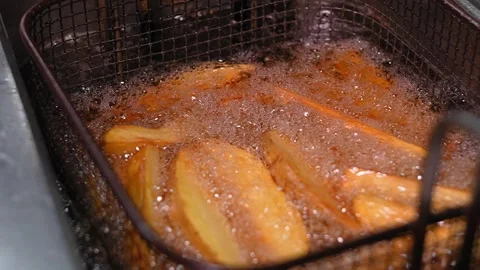 Experienced cook adding spices to pan-fried potatoes. Stock Footage 267279916