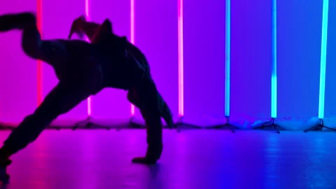 Experienced dancer performs complex break dance elements, spins on the floor and Stock Footage 144420314