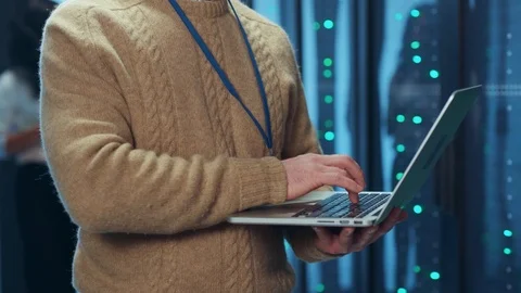 Experienced data operator typing on laptop keyboard doing cloud-based backup Stock Footage 125757754