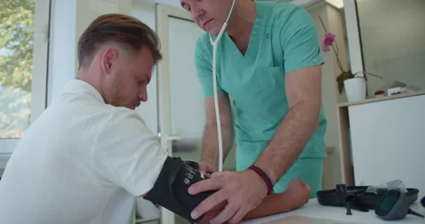Experienced doctor using stethoscope measuring patients breathing and pressure. Stock Footage 262471432