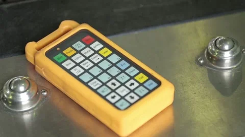 Experienced engineer in gloves takes yellow remote control Stock Footage 138941346