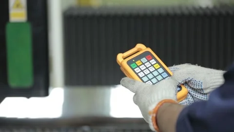 Experienced engineer moves blurry metal cutting machine Stock Footage 138879430