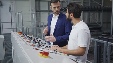 Experienced engineer showing machine control operating to new employee in mod 動画素材 108451427