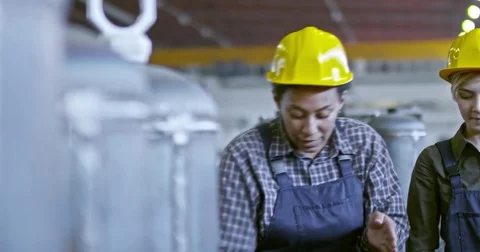 Experienced Female Factory Technician Teaching Young Employees Stock Footage