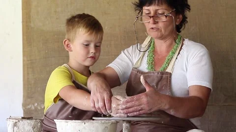 An experienced guide handles the potter young apprentice Video stock 54576657