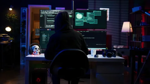 Experienced hacker writing lines of code on computer from underground bunker 库存影片 275750175