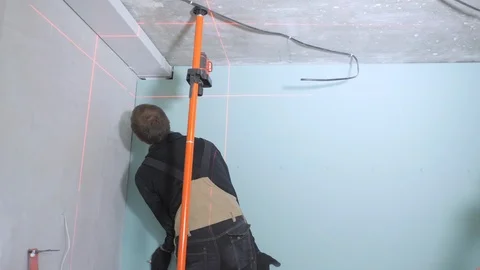 Experienced handyman fixes plasterboard on wall backside Video stock 108583200
