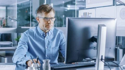 Experienced Industrial Engineer Working on Personal Computer in the Stylish,  Stock Photos