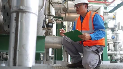 Experienced instrument engineer performing detailed equipment inspection and pro Stock Footage 335333434