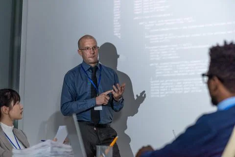 Experienced it-developer explaining new way of decoding data Stock Photos