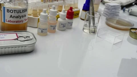 Experienced laboratory scientist analyzing a sample from a canned food can, botu Stock Footage 130248061