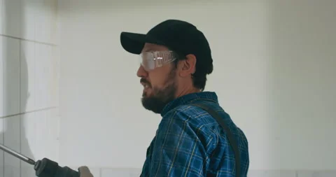 Experienced laborer working for years on construction sites renovating an Stock Footage 215737056