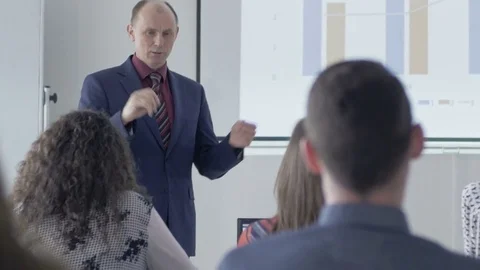 Experienced lecturer speaking in front of the classroom 動画素材 69930968