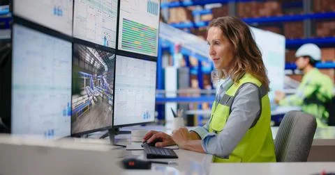 Experienced Logistics Manager Monitors Real-time Package Flow On Multiple Scr Stock Photos