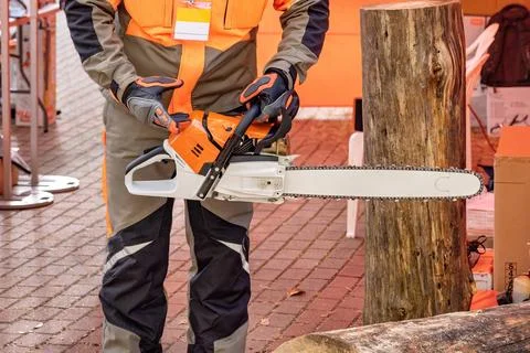 Experienced lumberjack demonstrates proper chainsaw handling at outdoor woo.. Stock Photos