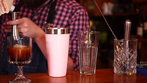 Experienced male bartender preparing milk alcohol cocktail in shaker performing Stock-Footage 103746924